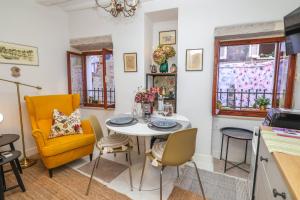 a kitchen and dining room with a table and chairs at Studio Hedera in Rovinj +18 photos