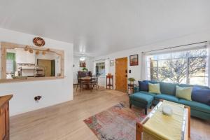 a living room with a blue couch and a table at Famed Plaza Oasis 1 mile away, King Bed, Office, Foosball in Santa Fe +33 photos