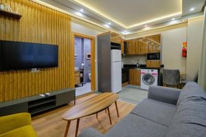 a living room with a couch and a tv on a wall at Private Apartment at Beylikdüzü nearly to E5 2 in Beylikduzu