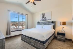 a bedroom with a large bed and a window at Private Hot Tub, Close to Resorts - Private Hot Tub - Close to PC, Mountain Mansion Family Getaway in Park City