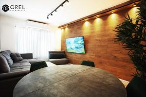 a living room with a table and a couch at orel's Top apartment in Eilat