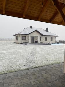 a house with a roof on top of a field at Dworek pod Krzyżtoporem Ujazd Agroturystyka- pokoje do wynajęcia in Iwaniska +66 photos