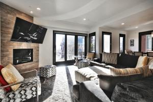 a living room with a couch and a fireplace at Juniper Landing - Luxury Townhouse - Outdoor Pool, Gym, Hot Tub in Canyons Village in Park City