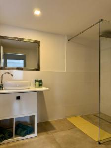 a bathroom with a sink and a mirror at Modern apartment in Albstadt