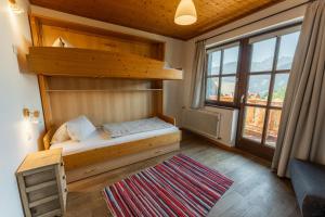 a small room with a bunk bed and a window at Bio Bauernhof Leitenmüller in Ramsau am Dachstein
