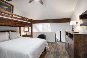 a bedroom with a bed and a desk with a television at Condo walk to Park City- Great views, Professional Interior in Park City