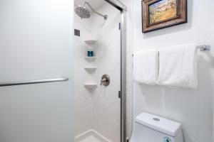 a white bathroom with a shower and a toilet at Condo walk to Park City- Great views, Professional Interior in Park City +28 photos