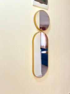 a mirror hanging on a wall with a mirror at Lifestyle furnished 2 bedroom Mtwapa in Mombasa +16 photos