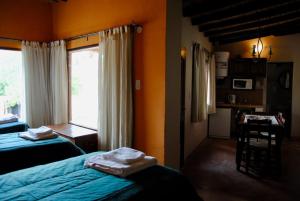a hotel room with two beds and a window at ENTRECERROS, Tilcara in Tilcara +9 photos