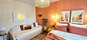 a living room with two beds and a couch at Dépaysant à Poitiers in Poitiers