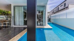 an external view of a house with a swimming pool at Sandcastles in Casuarina