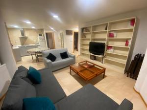 a large living room with a couch and a table at Estación 1 in Murcia