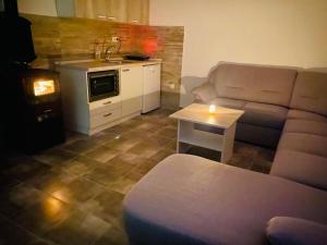 a living room with a couch and a table with a candle at dr Genius Cottage in Negotin