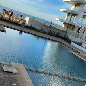 a large swimming pool in front of a building at Luxury Sea View -Gym-Pool-Carrousel Mall in Rabat