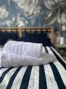 three towels are stacked on top of a bed at Ferienwohnung Familie Renner in Cappel-Neufeld