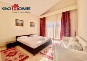 a hotel room with a bed and a window at Stylish 4 BR with a Private Heated Pool V15 at White Villas in Hurghada