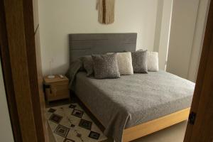 a bedroom with a large bed and a night stand at Norte Cali - Bosque Living -201 in Cali