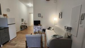 a living room with a couch and a refrigerator at L'aT3lier d'Orthez in Orthez