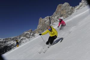two people skiing down a snow covered mountain at Gasthof Edelweiss in Tires