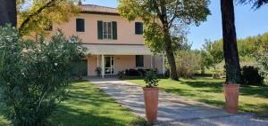 a large house with trees in the yard at Locanda Corte Roveri in Bologna