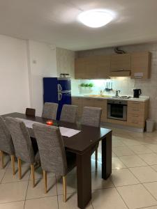 a kitchen with a dining room table and chairs at Apartman276eu Passo del Tonale in Passo del Tonale +36 photos