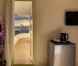 a door to a balcony with a view of a room at Pyramids Art Inn in Cairo
