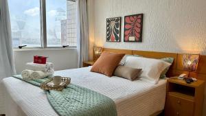 a bedroom with a bed with a tray on it at (1002) Flat on Ponta da Areia Beach in São Luís +30 photos