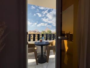 a room with a table and a view of a balcony at Pyramids Art Inn in Cairo