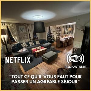 a living room with a couch and a table at Gîte de charme jusqu'à 14 personnes, Proche du lac de Gérardmer in Gérardmer