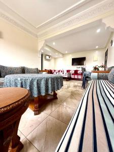 a living room with two tables and a couch at Appartement en résidence privée in Marrakech