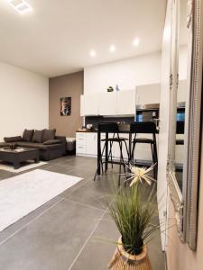 a kitchen and living room with two chairs and a table at Cozy Apartments in Central Location with Free Parking on Availability in Vienna