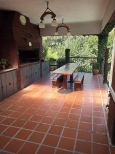 eine Terrasse mit einem Tisch und Bänken darauf in der Unterkunft La Morada in Mina Clavero