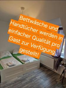 a bedroom with a bed with a sign on it at Ausblick Freital 2 in Freital