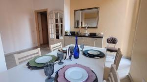 a dining room with a white table and chairs at Rome Central Rooms in Rome +57 photos