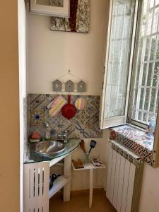 a small bathroom with a sink and a window at Ai Baretti B&B in Naples +35 photos