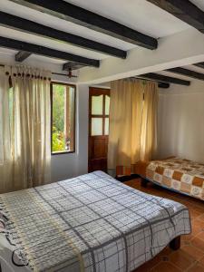 Postel nebo postele na pokoji v ubytování Hostal Pachamama