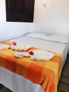 two beds in a room with towels on them at Pousada Bella Maré in Goiana +43 photos