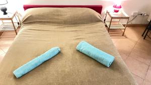 two pillows on a bed in a room at Ai Baretti B&B in Naples