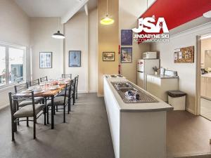 a kitchen and dining room with a long table with chairs at Razorback 2 in Jindabyne