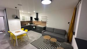 a living room with a couch and a table and chairs at Apartmány pod Chočom, Dolný Kubín in Vyšný Kubín