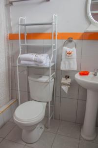 a bathroom with a toilet and a sink at Hotel Chachapoyas in Chachapoyas