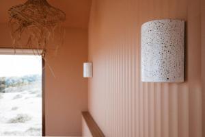 a lamp hanging on a wall next to a window at EyreWay in Tulka