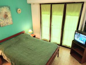 Ένα ή περισσότερα κρεβάτια σε δωμάτιο στο Duplex Punta Mogotes, Mar del Plata