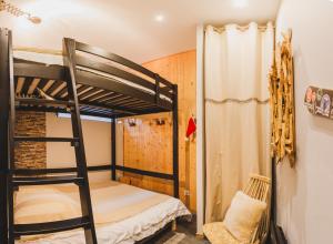 a bunk bed room with two bunk beds and a ladder at L'Eveil - 65m2 - 6-8P - Centre Ville Cauterets in Cauterets
