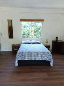 a bedroom with a large bed with a window at casa y monoambiente Britopolis in Fomento