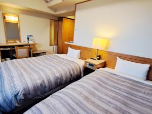 Postel nebo postele na pokoji v ubytování Hotel Route-Inn Mooka