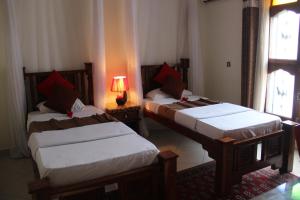 Rúm í herbergi á Al-Minar Hotel