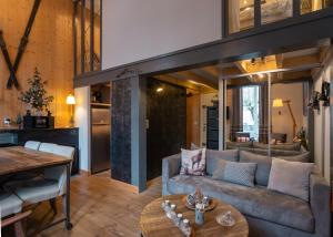 a living room with a couch and a table at L'Eveil - 65m2 - 6-8P - Centre Ville Cauterets in Cauterets