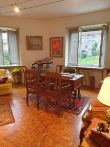 a living room with a wooden table and chairs at B&B del centro in Pinerolo