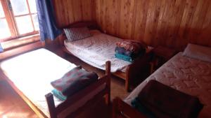 Ένα ή περισσότερα κρεβάτια σε δωμάτιο στο Cabañas Rucatregua